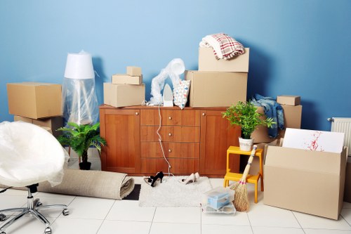 House removal team working in Borough with moving boxes and furniture