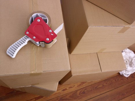 Packed boxes and furniture ready for loading into a Borough moving truck