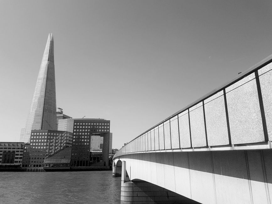 The image depicts a historic church with a tall, pointed spire illuminated by warm sunlight, situated in Southwark near Borough. The church's exterior features intricate stonework, including large cir